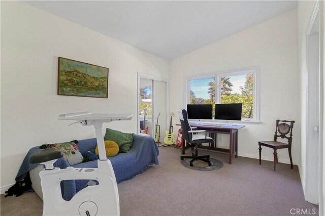 office featuring baseboards, vaulted ceiling, and carpet flooring