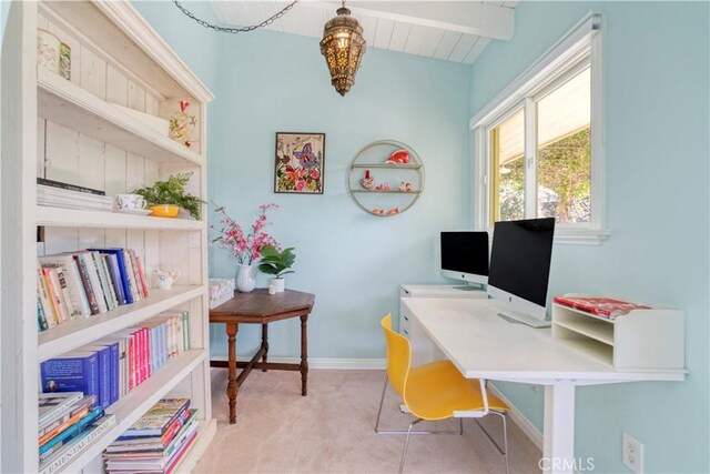 office area featuring lofted ceiling with beams, carpet, and baseboards