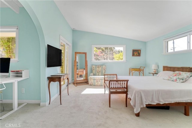 bedroom with carpet, baseboards, vaulted ceiling, and arched walkways