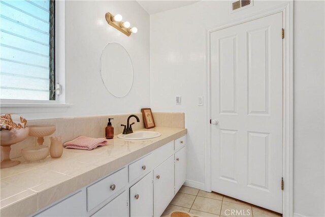 bathroom with tile patterned floors, visible vents, and vanity