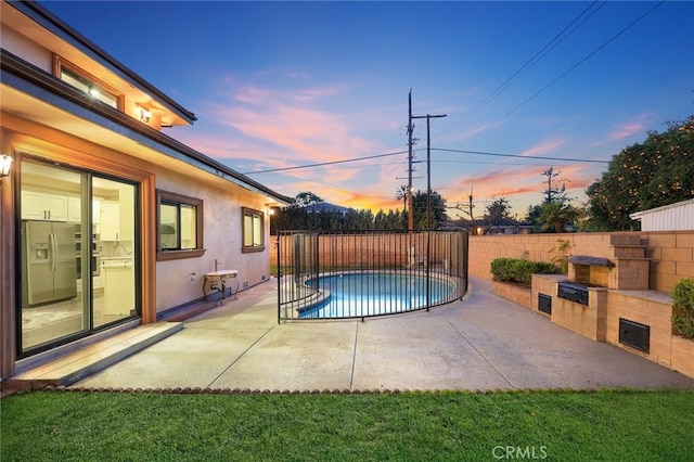 view of pool featuring a patio area, a fenced backyard, and a fenced in pool