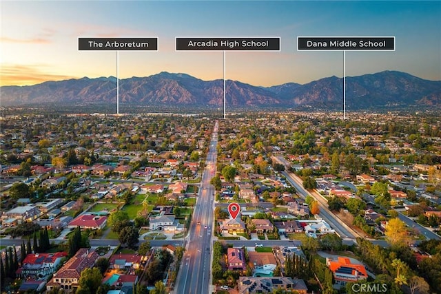 aerial view at dusk featuring a residential view and a mountain view