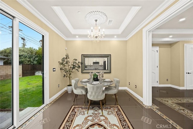 tiled dining space with a chandelier, visible vents, baseboards, ornamental molding, and a tray ceiling