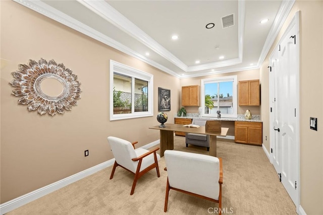 office space with light carpet, visible vents, baseboards, a raised ceiling, and crown molding