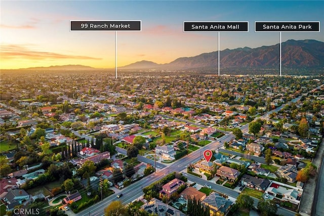 aerial view at dusk featuring a residential view and a mountain view