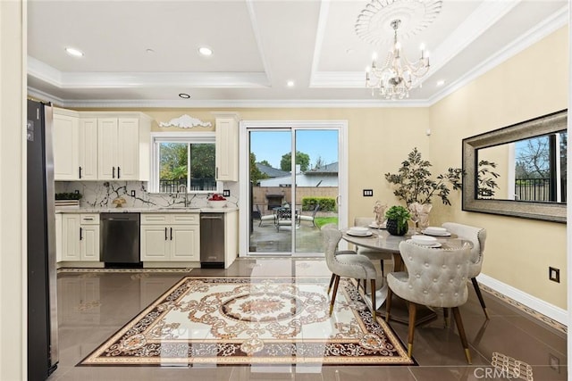 kitchen featuring freestanding refrigerator, a sink, a chandelier, dishwasher, and baseboards