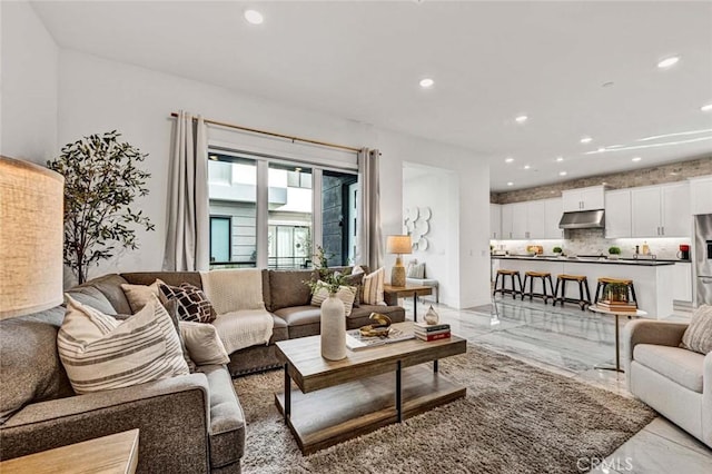 living area with marble finish floor and recessed lighting