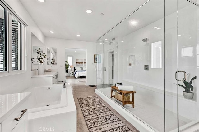 full bath with plenty of natural light, a shower stall, connected bathroom, and recessed lighting