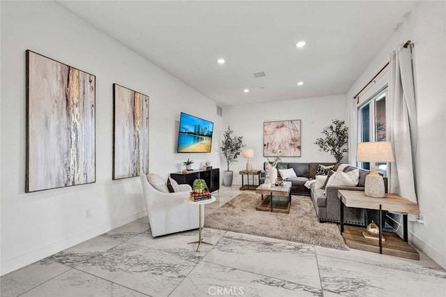 living area featuring marble finish floor, baseboards, and recessed lighting