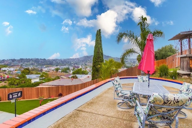 view of patio with a fenced backyard and a mountain view