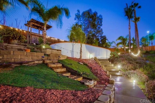 view of yard with stairs and fence