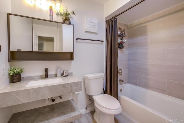 bathroom featuring toilet, a sink, and shower / tub combo with curtain