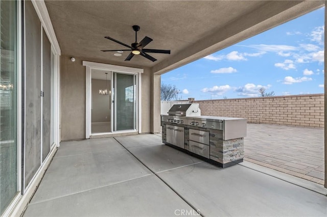 view of patio / terrace with exterior kitchen, a grill, and a ceiling fan