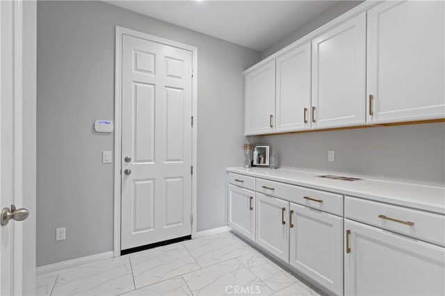 interior space featuring marble finish floor and baseboards