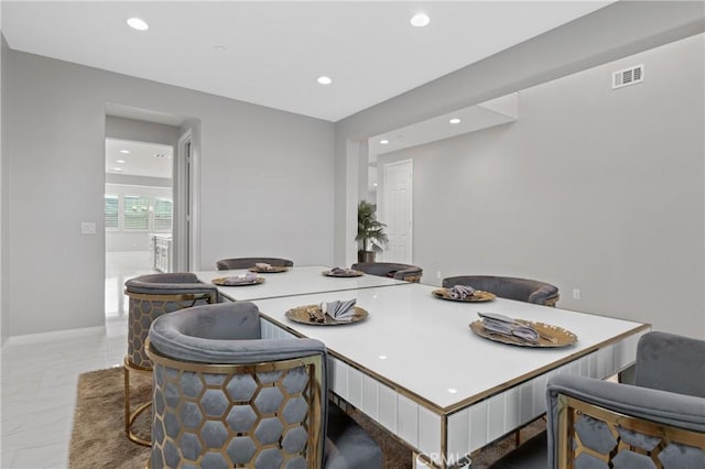 dining space with recessed lighting, marble finish floor, visible vents, and baseboards