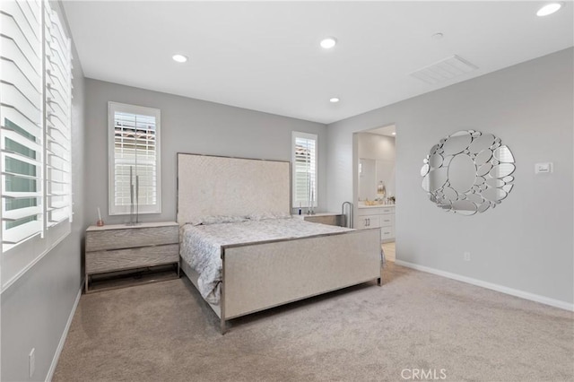 carpeted bedroom featuring recessed lighting, visible vents, connected bathroom, and baseboards