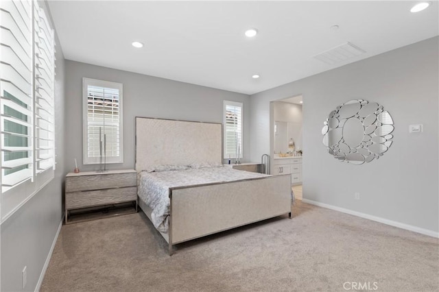 29945 Urtica Ct, Menifee, CA 92584 - carpeted bedroom featuring baseboards, ensuite bath, visible vents, and recessed lighting