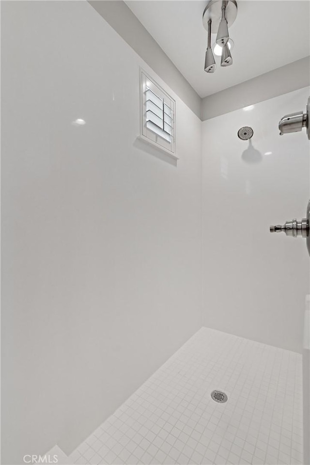 full bath with a tile shower