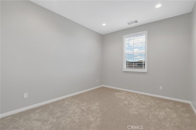 unfurnished room featuring light carpet, recessed lighting, visible vents, and baseboards