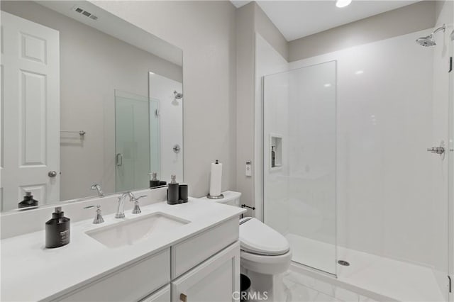 bathroom with toilet, vanity, visible vents, marble finish floor, and a stall shower