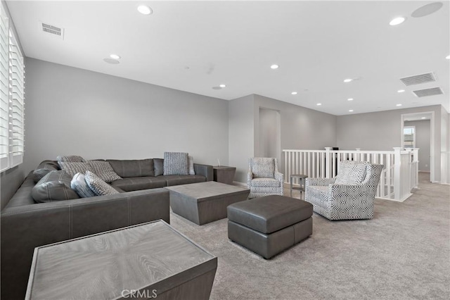 living room with carpet flooring, visible vents, and recessed lighting