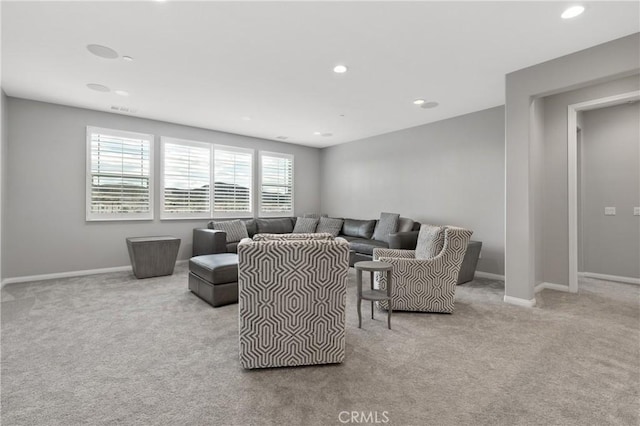 carpeted living area featuring recessed lighting, visible vents, and baseboards