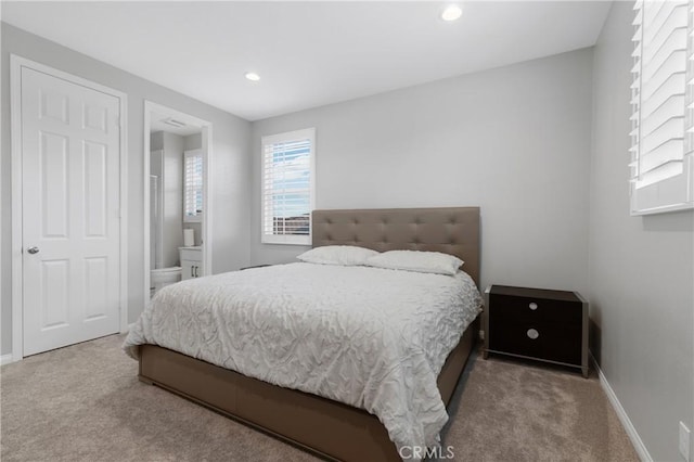 bedroom featuring connected bathroom, baseboards, carpet flooring, and recessed lighting