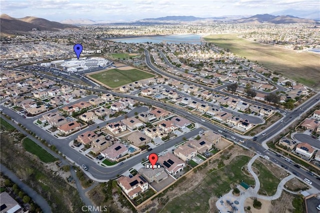 drone / aerial view featuring a residential view and a water and mountain view