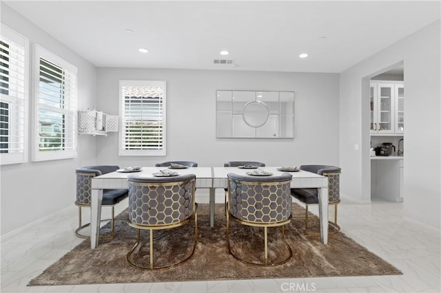 dining room featuring baseboards, marble finish floor, visible vents, and recessed lighting