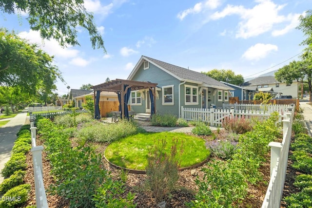 view of front of property with a pergola and a fenced front yard