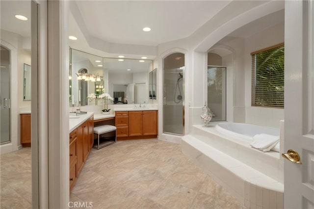 bathroom featuring a stall shower, vanity, a bath, and recessed lighting