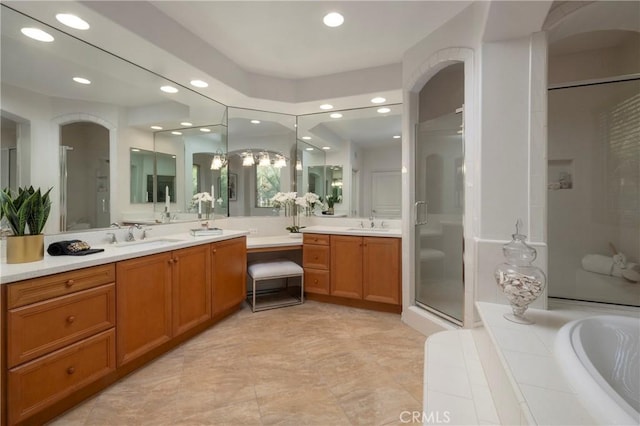 bathroom with a washtub, a stall shower, vanity, and recessed lighting