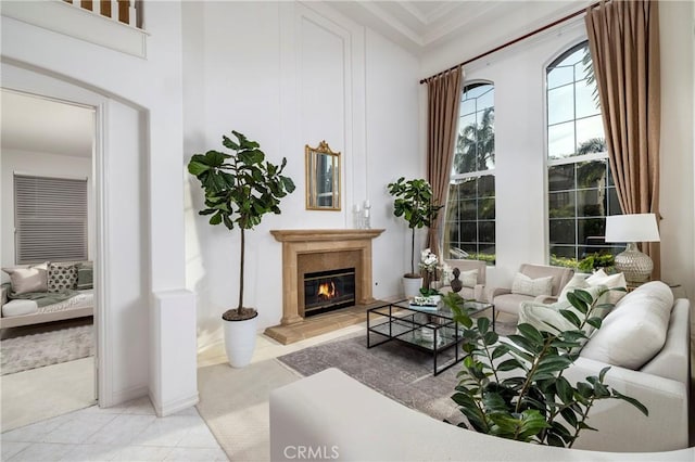 living area with light tile patterned floors and a tiled fireplace