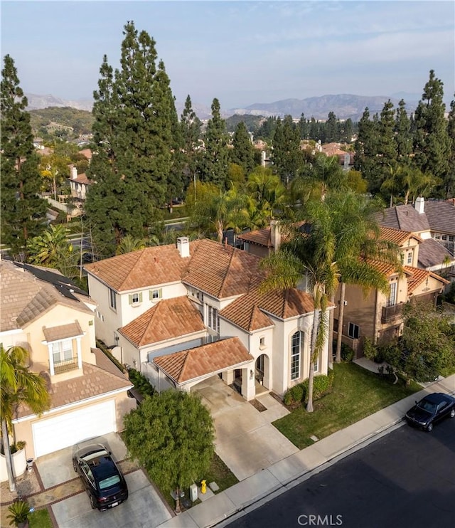 birds eye view of property with a mountain view and a residential view