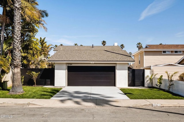 view of front of house with an attached garage, fence, roof with shingles, stucco siding, and driveway