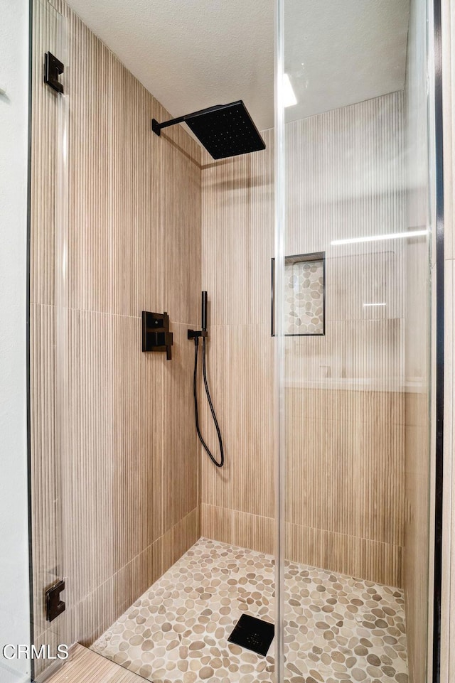 bathroom with tiled shower