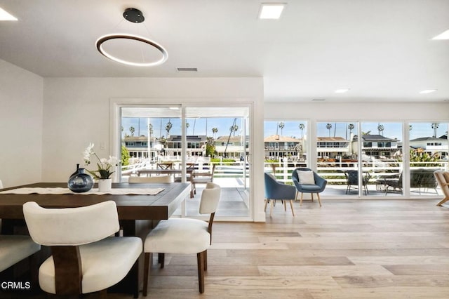 dining room featuring wood finished floors and visible vents