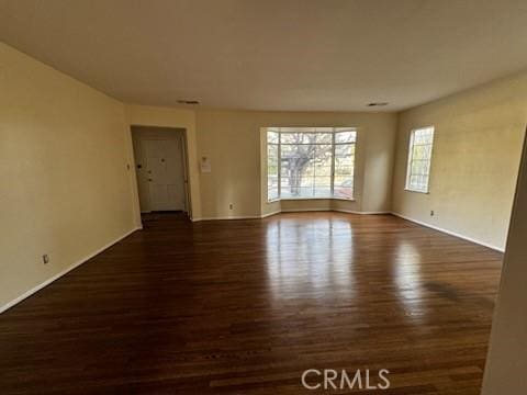 spare room with wood finished floors