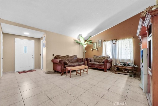 living room with lofted ceiling and light tile patterned floors