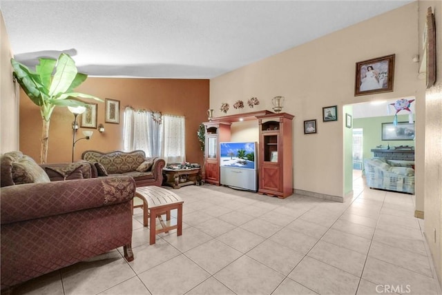 living room featuring light tile patterned floors and vaulted ceiling