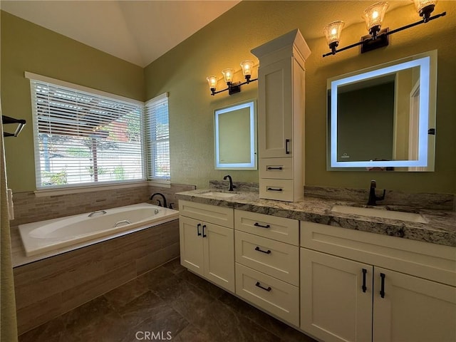 bathroom with a sink, lofted ceiling, a garden tub, and double vanity