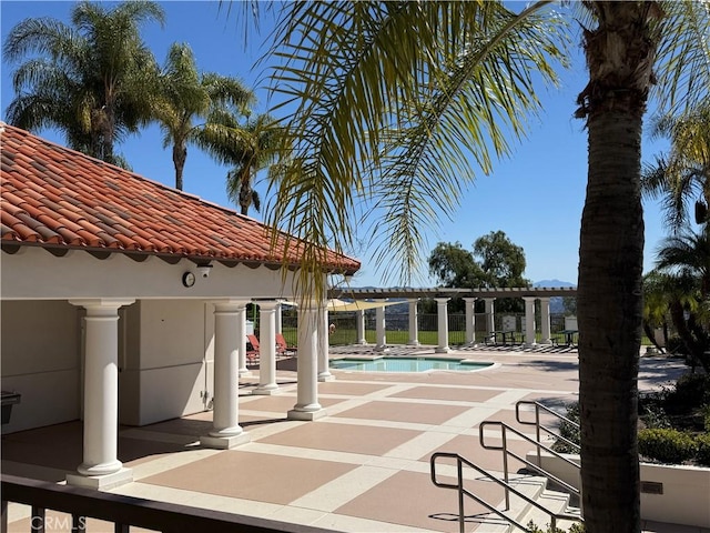 community pool featuring a gazebo, a patio, and a pergola