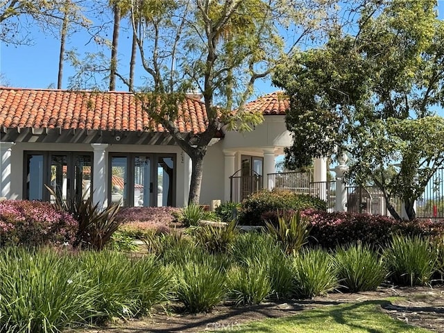 view of front of property with a tile roof and stucco siding