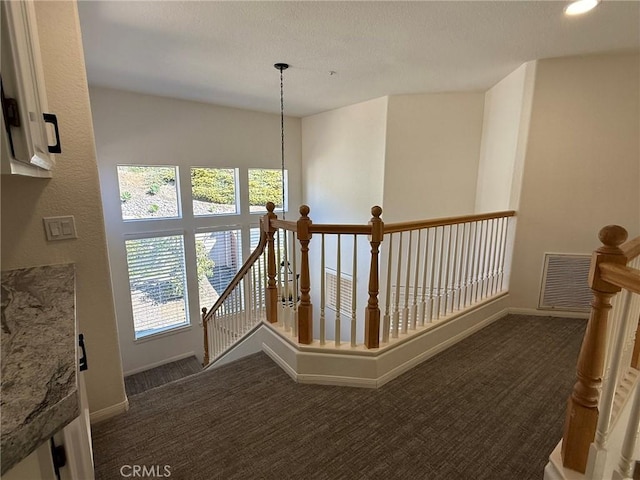 stairs featuring visible vents, baseboards, and carpet