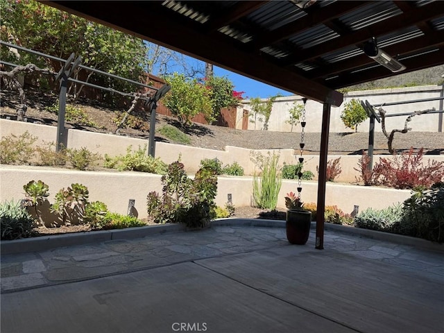 view of patio featuring fence