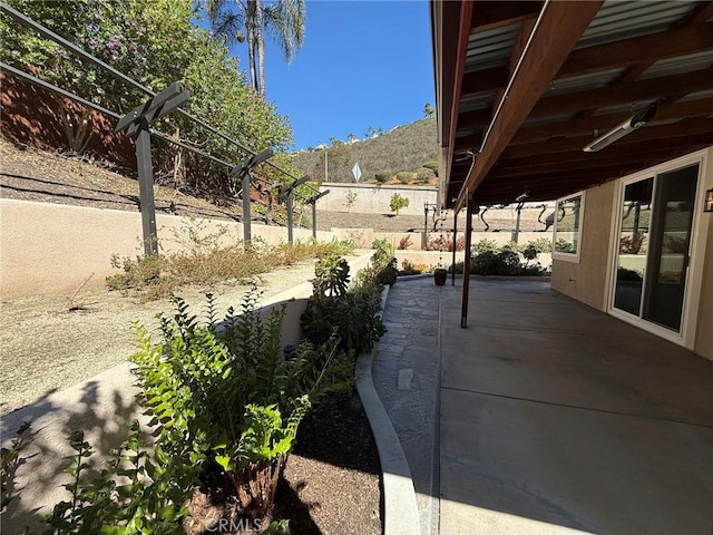 view of patio / terrace featuring fence