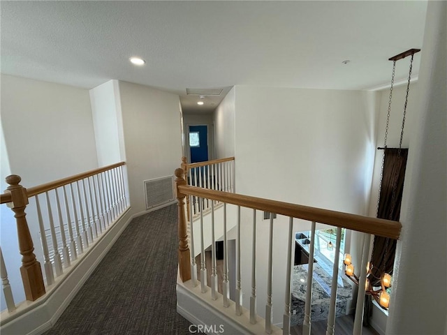 corridor with recessed lighting, an upstairs landing, visible vents, and carpet floors