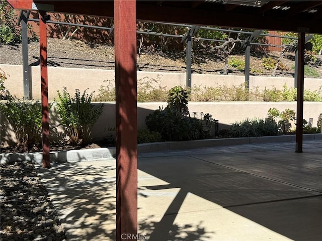 view of patio / terrace featuring fence