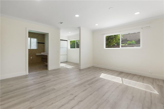 spare room with recessed lighting, baseboards, light wood-style floors, and crown molding