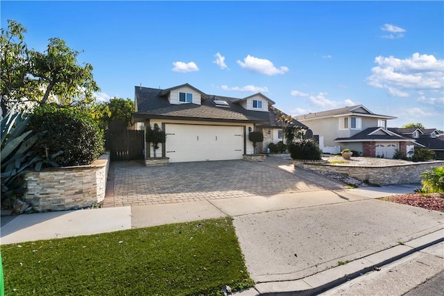 view of front of house with decorative driveway and a garage